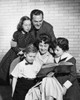 Mid adult couple with their children looking at a picture book Poster Print - Item # VARSAL25519221