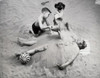 High angle view of a brother and his sister burying their father on the beach Poster Print - Item # VARSAL255512