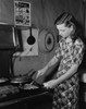Young woman cooking food in the kitchen Poster Print - Item # VARSAL9901965