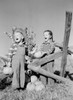 Boy and girl with pumpkins on farm Poster Print - Item # VARSAL255423334