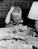 Boy looking at bills and scratching his head Poster Print - Item # VARSAL2551151A