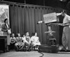 Group of children and a woman performing in a television studio Poster Print - Item # VARSAL2551652B