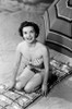 Portrait of young woman sitting on beach Poster Print - Item # VARSAL255417477