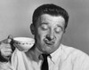 Mature man holding tea cup and making a face Poster Print - Item # VARSAL2554250
