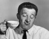 Mature man holding tea cup and making a face Poster Print - Item # VARSAL2554250
