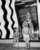 Rear view of a girl and a boy looking in a fun house mirror Poster Print - Item # VARSAL255975