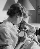 Young woman feeding her baby with a baby bottle Poster Print - Item # VARSAL2559836