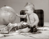 1960s Baby Seated Looking At Globe With Camera Binoculars Suitcase And Travel Brochures Print By Vintage Collection - Item # PPI177081LARGE