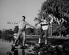 Young couple standing on pebble at lakeshore Poster Print - Item # VARSAL255423339
