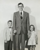 Portrait of a mid adult man standing with his son and daughter Poster Print - Item # VARSAL25519517