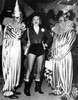 Portrait of young smiling woman standing with two clowns Poster Print - Item # VARSAL9903238