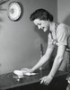 Side profile of a young woman cleaning a table Poster Print - Item # VARSAL255396