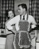 Woman helping man to put on apron Poster Print - Item # VARSAL25541264