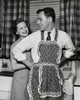 Woman helping man to put on apron Poster Print - Item # VARSAL25541264