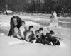 Family playing in the snow on a sled Poster Print - Item # VARSAL25515410