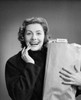 Young woman holding a shopping bag and smiling Poster Print - Item # VARSAL25521733