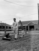 Father mowing lawn with son in back yard Poster Print - Item # VARSAL255416866
