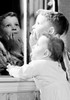 Two kids looking through window Poster Print