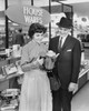 Mid adult woman and a mature man looking at a kettle in a store Poster Print - Item # VARSAL2551455
