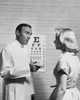 Male optometrist talking to a patient Poster Print - Item # VARSAL25526457