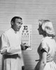 Male optometrist talking to a patient Poster Print - Item # VARSAL25526457
