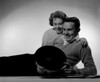 Young couple lying on floor looking at record Poster Print - Item # VARSAL255416813