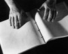 High angle view of a person's hand reading Braille Poster Print - Item # VARSAL25527814