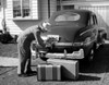 Man loading luggage into car trunk Poster Print - Item # VARSAL25528093