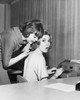 Side profile of a businesswoman whispering to another businesswoman in an office Poster Print - Item # VARSAL25523250
