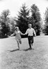 Young couple running in forest Poster Print - Item # VARSAL255416487