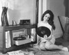 Young woman looking at a record and smiling Poster Print - Item # VARSAL2552289B