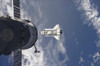 Space Shuttle Atlantis and a Russian spacecraft backdropped by a blue and white Earth Poster Print