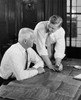 Two businessmen discussing blueprint in office Poster Print - Item # VARSAL25547976
