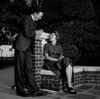 Man talking to woman sitting on wall Poster Print - Item # VARSAL255417154