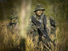 U.S. Navy SEALs walk through tall grass during combat operations Poster Print - Item # VARPSTTWE300049M