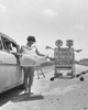 Young woman reading a map in front of a road closed sign Poster Print - Item # VARSAL25547715