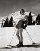 Young woman standing with skiing equipment and smiling Poster Print - Item # VARSAL25515240