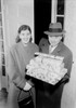 Couple carrying Christmas presents in doorway Poster Print - Item # VARSAL255422275
