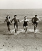 Two young couples running on the beach Poster Print - Item # VARSAL2552987