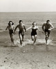 Two young couples running on the beach Poster Print - Item # VARSAL2552987