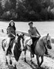 Young couple riding horses in a field Poster Print - Item # VARSAL25541383