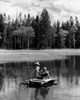 Vintage photograph of boy and girl sitting on wooden raft  fly-fishing with improvised fishing rods on lake Poster Print - Item # VARSAL25516349