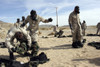 November 22, 2005 - Marines and Sailors assist each other in taking off their Mission Oriented Protective Posture suits moments after exiting the gas Chamber. Poster Print - Item # VARPSTSTK102051M