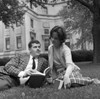 Young couple reading book on lawn Poster Print - Item # VARSAL255421025