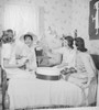 Four young women fitting hats in bedroom Poster Print - Item # VARSAL255422708A