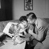 Mid adult couple looking at photograph in magazine Poster Print - Item # VARSAL255418047