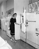 Young woman looking at refrigerators in a store Poster Print - Item # VARSAL25536937