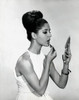 Studio shot of young woman applying lipstick Poster Print - Item # VARSAL2556908 Studio shot of young woman applying lipstick Poster Print - Item # VARSAL2556908