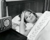 High angle view of a mid adult woman lying in bed suffering from a headache Poster Print - Item # VARSAL25534728