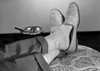 Low section of man relaxing with legs crossed at ankles Poster Print - Item # VARSAL25549326